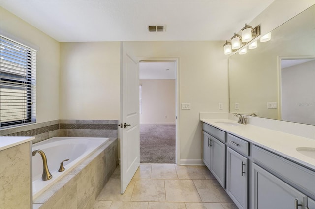 15088 Night Heron Dr, Winter Garden, FL 34787 - bathroom featuring double vanity, a bath, and tile patterned floors