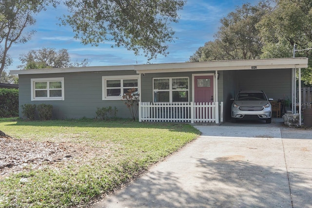 ranch-style house featuring a front lawn and a carport