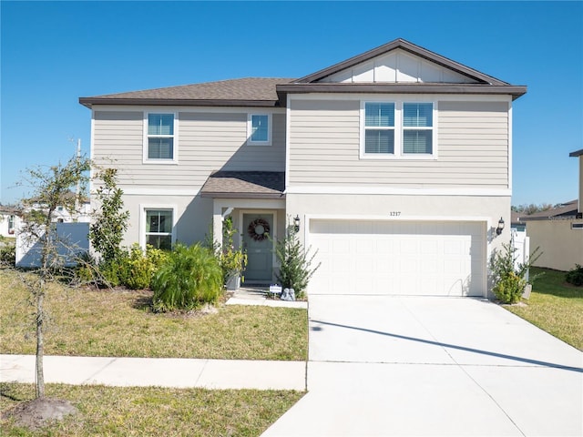 view of front facade featuring a front lawn and a garage