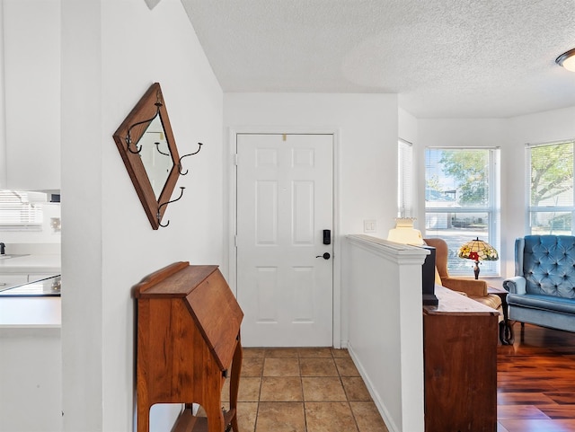 foyer entrance featuring a textured ceiling