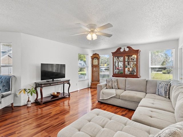 living room featuring a textured ceiling, hardwood / wood-style flooring, and ceiling fan