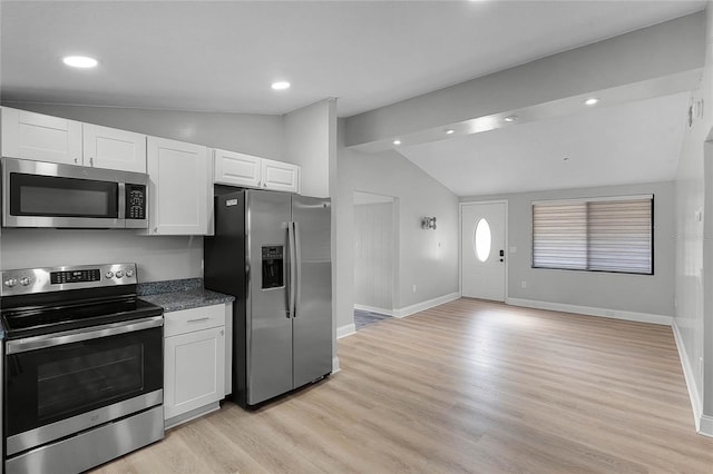 kitchen with light hardwood / wood-style flooring, stainless steel appliances, white cabinetry, and lofted ceiling