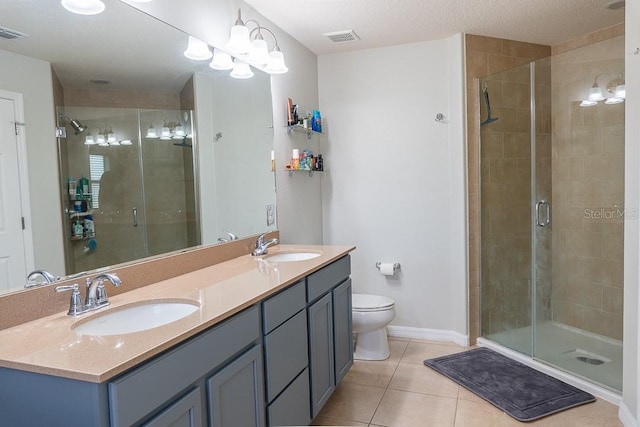 bathroom with a stall shower, tile patterned flooring, visible vents, and a sink