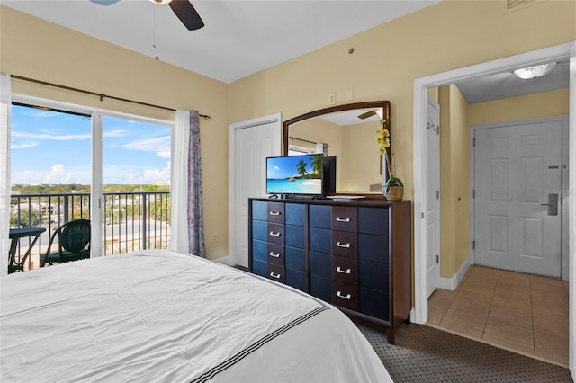 carpeted bedroom with access to outside, ceiling fan, baseboards, and tile patterned floors