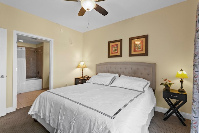 carpeted bedroom featuring tile patterned flooring, baseboards, and connected bathroom