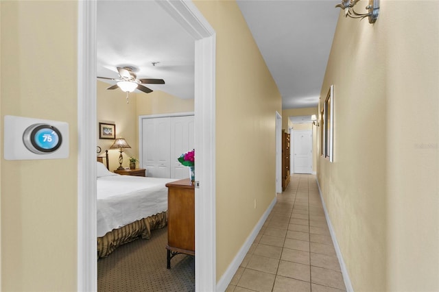 hall with light tile patterned floors and baseboards