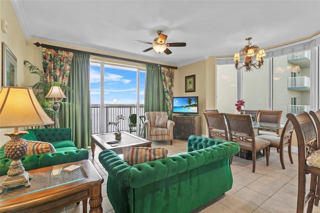 living area featuring ceiling fan with notable chandelier, ornamental molding, and light tile patterned flooring