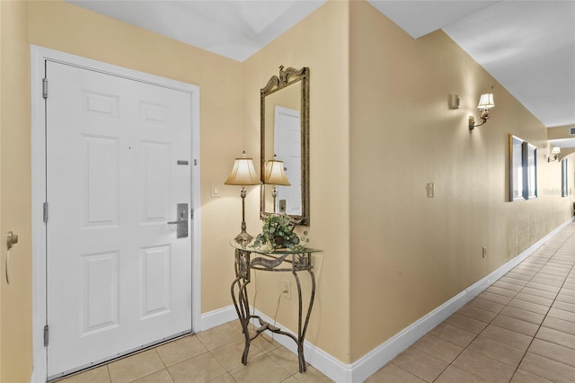 entrance foyer with baseboards and light tile patterned floors