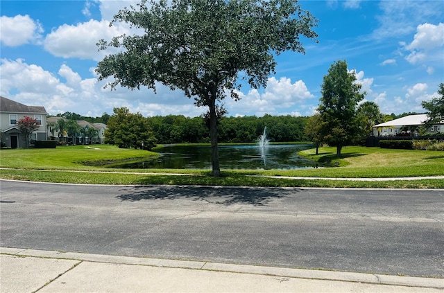 surrounding community featuring a yard and a water view