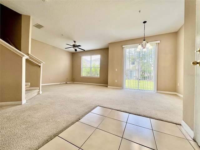 6640 S Goldenrod Rd Unit 118B, Orlando, FL 32822 - carpeted empty room with baseboards, a chandelier, a ceiling fan, and stairs