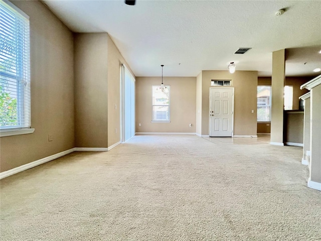 6640 S Goldenrod Rd Unit 118B, Orlando, FL 32822 - unfurnished living room featuring baseboards and light carpet