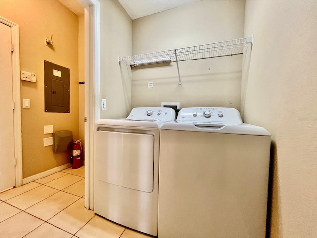 6640 S Goldenrod Rd Unit 118B, Orlando, FL 32822 - washroom with electric panel, washer and clothes dryer, light tile patterned flooring, and baseboards