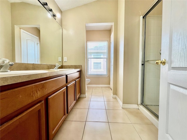 6640 S Goldenrod Rd Unit 118B, Orlando, FL 32822 - bathroom with double vanity, toilet, a shower with door, tile patterned flooring, and baseboards
