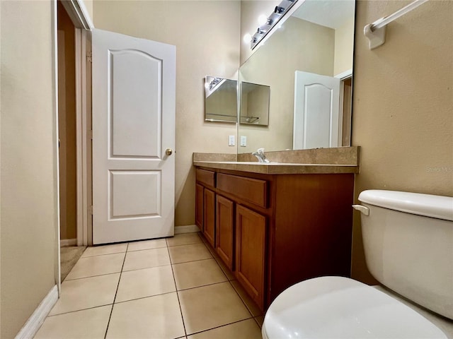 6640 S Goldenrod Rd Unit 118B, Orlando, FL 32822 - bathroom featuring toilet, vanity, tile patterned floors, and baseboards