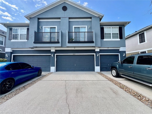 6640 S Goldenrod Rd Unit 118B, Orlando, FL 32822 - townhome / multi-family property featuring stucco siding, a garage, a balcony, and driveway