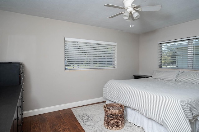 bedroom with dark wood-type flooring and ceiling fan