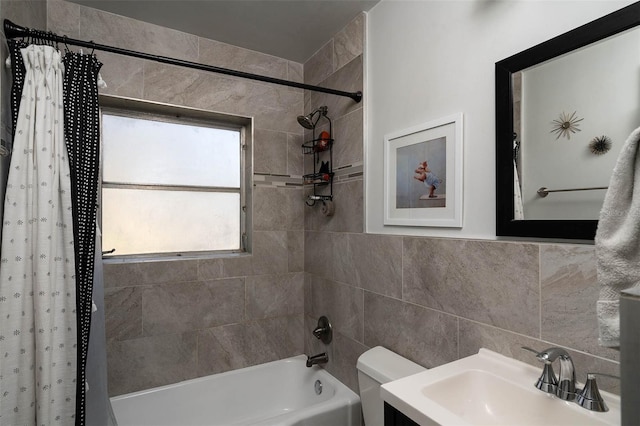 full bathroom featuring vanity, tile walls, toilet, and shower / tub combo