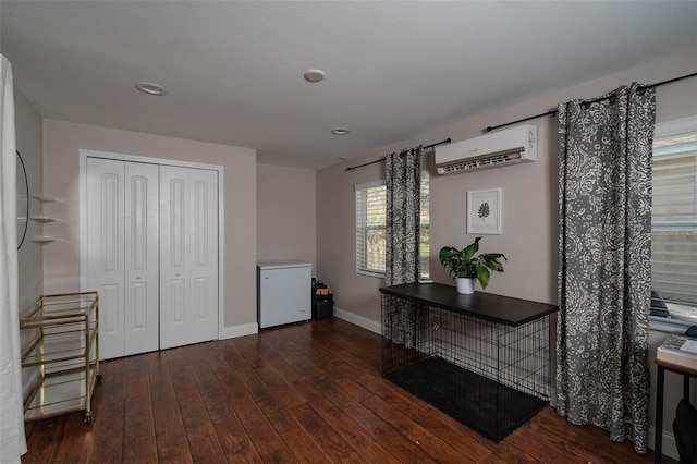 interior space featuring an AC wall unit and dark hardwood / wood-style flooring