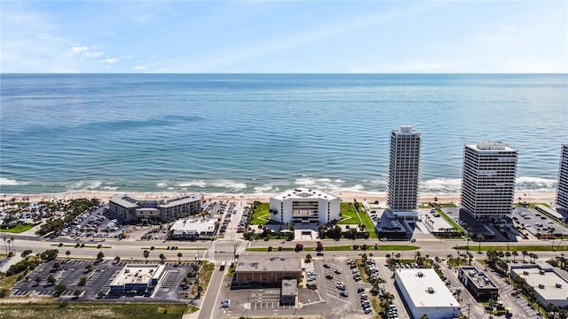 birds eye view of property featuring a beach view and a water view