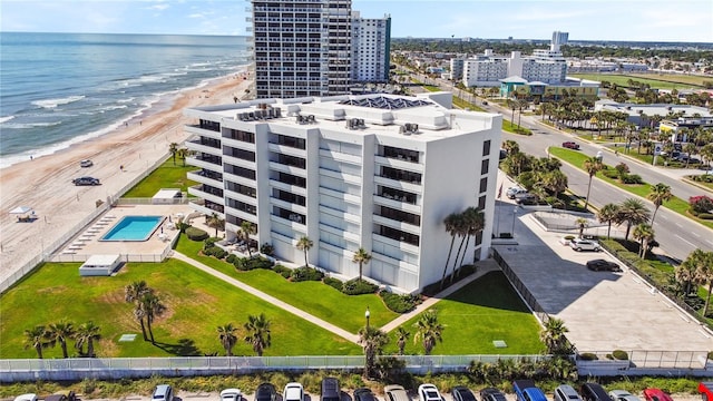 drone / aerial view featuring a water view and a view of the beach