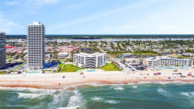 drone / aerial view with a water view and a beach view