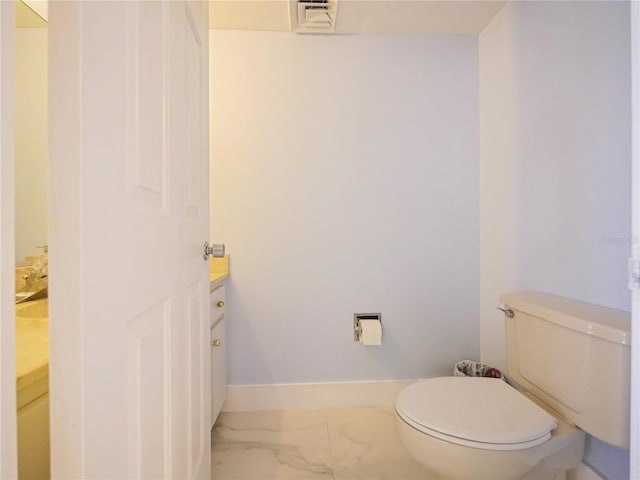 bathroom featuring toilet and vanity