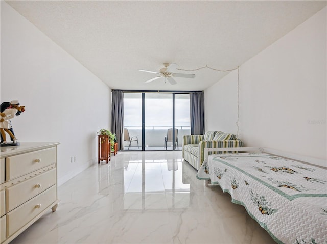 bedroom featuring a textured ceiling, access to exterior, a wall of windows, and ceiling fan