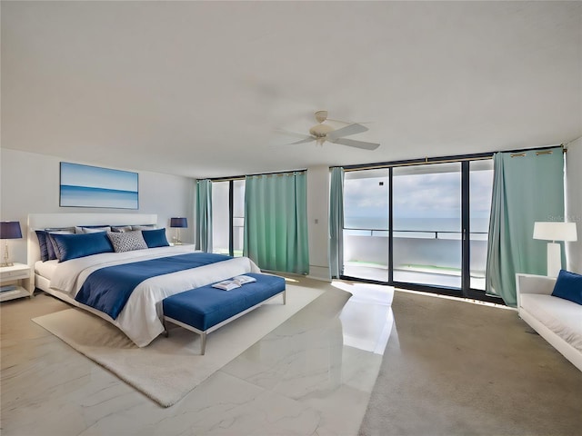 bedroom featuring access to exterior, floor to ceiling windows, a water view, and ceiling fan