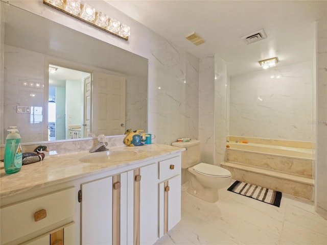 bathroom with a tub, vanity, and toilet