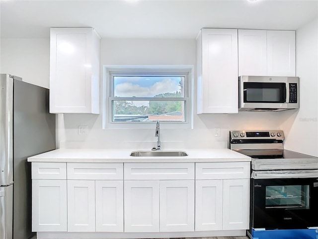 kitchen with white cabinetry, sink, and stainless steel appliances