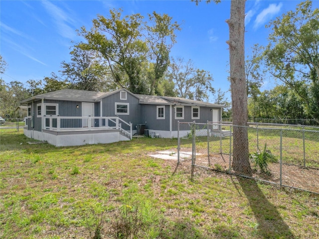 4502 Florence St, Apopka, FL 32712 - back of property with central AC unit, a yard, and a wooden deck