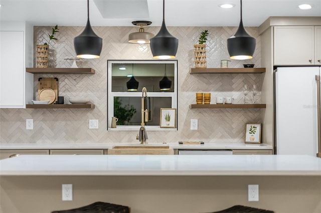 kitchen featuring decorative light fixtures, white appliances, white cabinetry, and decorative backsplash