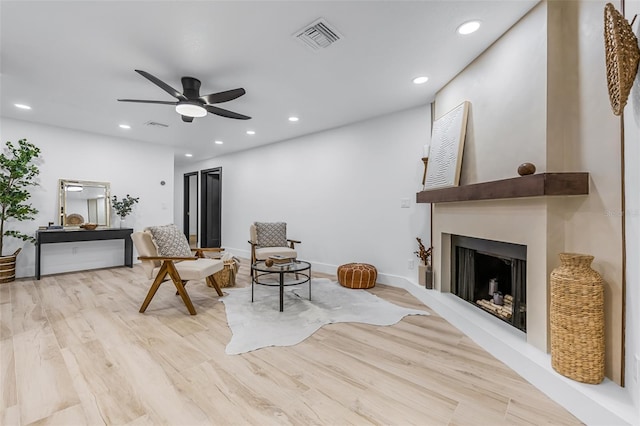 sitting room featuring ceiling fan and light hardwood / wood-style floors