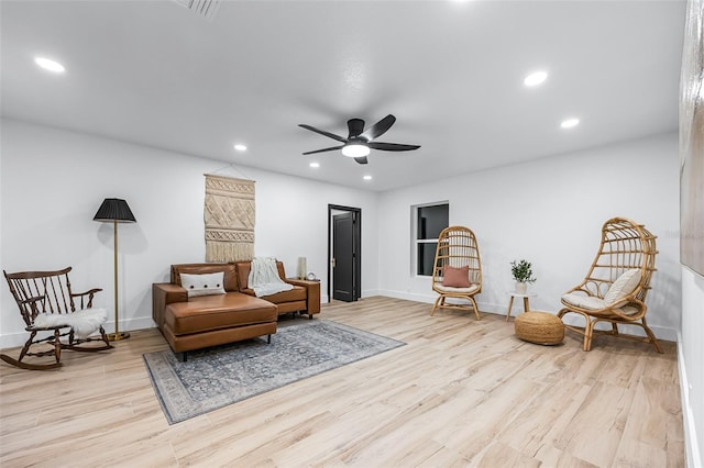 living area featuring ceiling fan and light wood-type flooring