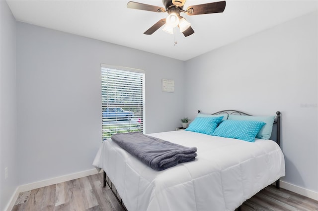 bedroom with light hardwood / wood-style floors and ceiling fan