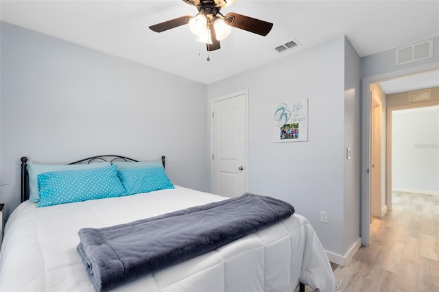 bedroom with ceiling fan and light hardwood / wood-style floors