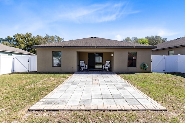 back of house with a yard and a patio area