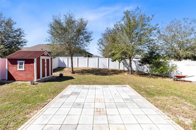 view of yard featuring a storage unit and a patio area