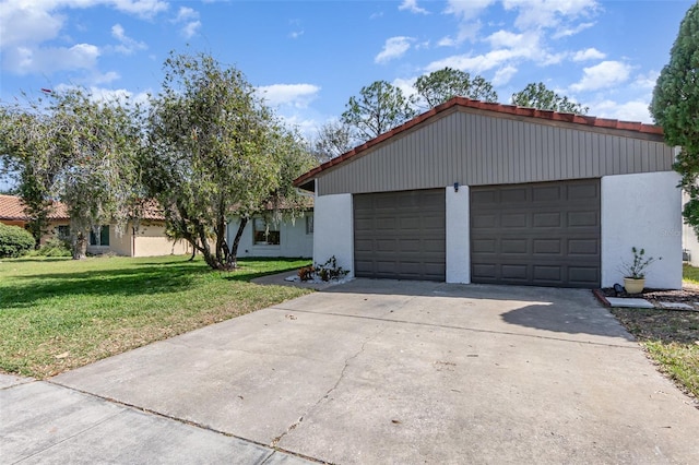 mid-century inspired home with a garage, a front yard, driveway, and stucco siding