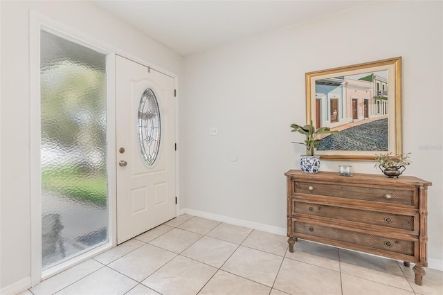 foyer with light tile patterned floors and baseboards