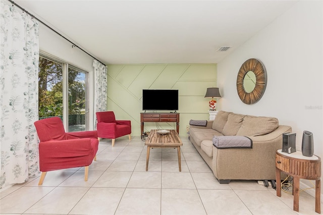 living area with visible vents and tile patterned floors