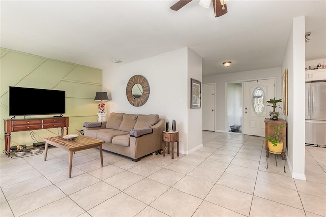 living room with visible vents, light tile patterned flooring, a ceiling fan, and baseboards