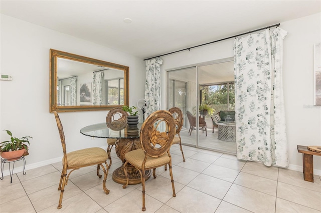 dining room featuring light tile patterned floors and baseboards