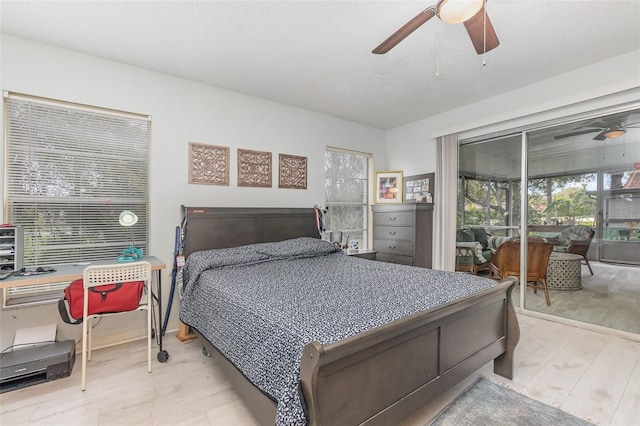 bedroom with access to exterior, a ceiling fan, and wood finished floors