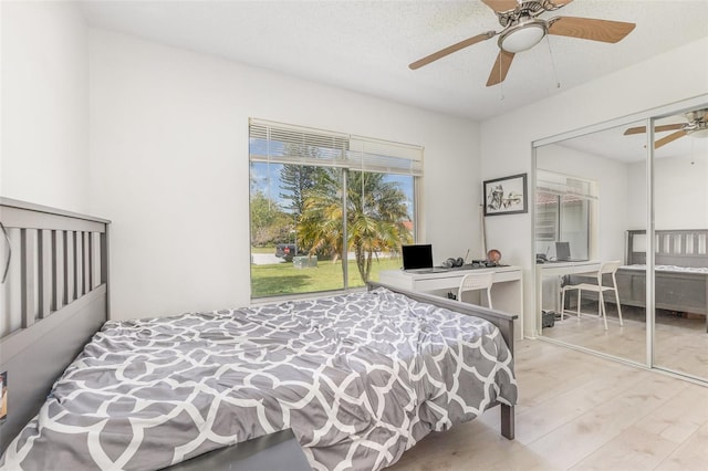 bedroom with ceiling fan, a closet, and wood finished floors