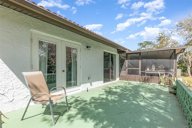 view of patio with a sunroom