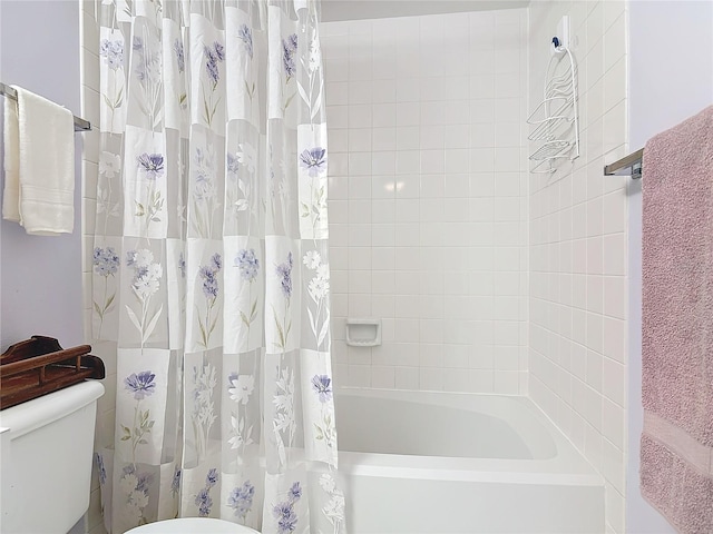 bathroom featuring shower / bath combination with curtain and toilet