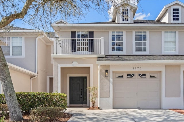 multi unit property with a garage and a balcony