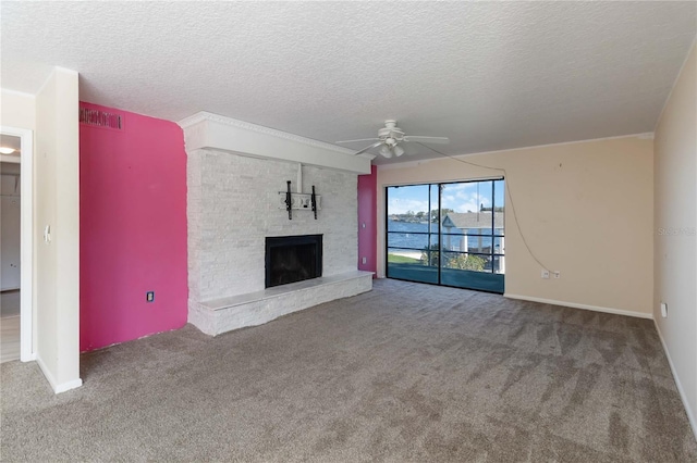 unfurnished living room with a fireplace, carpet flooring, a textured ceiling, and ceiling fan