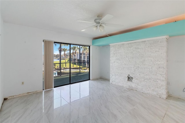 spare room featuring a textured ceiling and ceiling fan